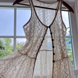 Lace, sleeveless, open front top.